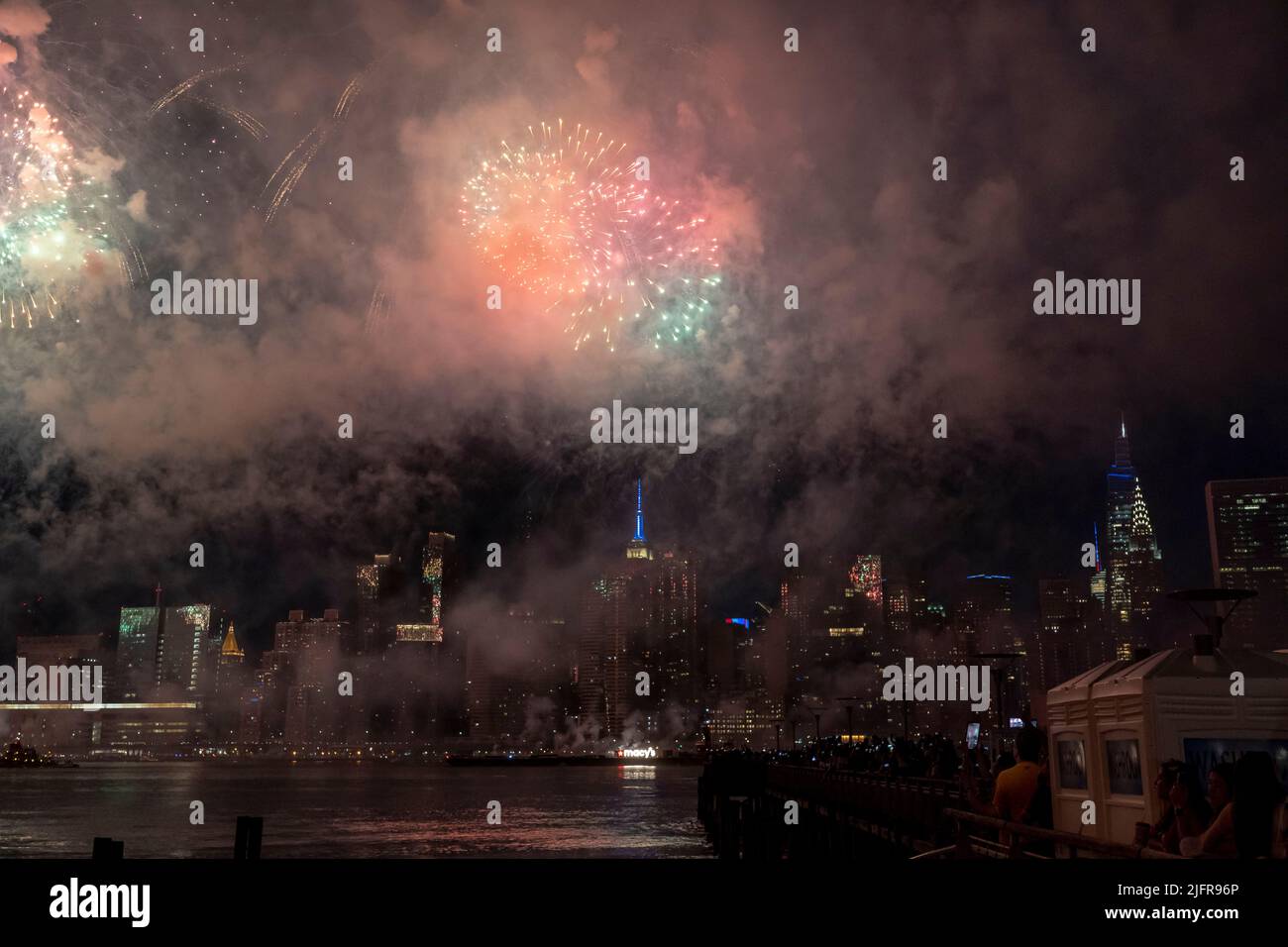 NEW YORK, NY - JULY 04: Fireworks explode over the east river during ...