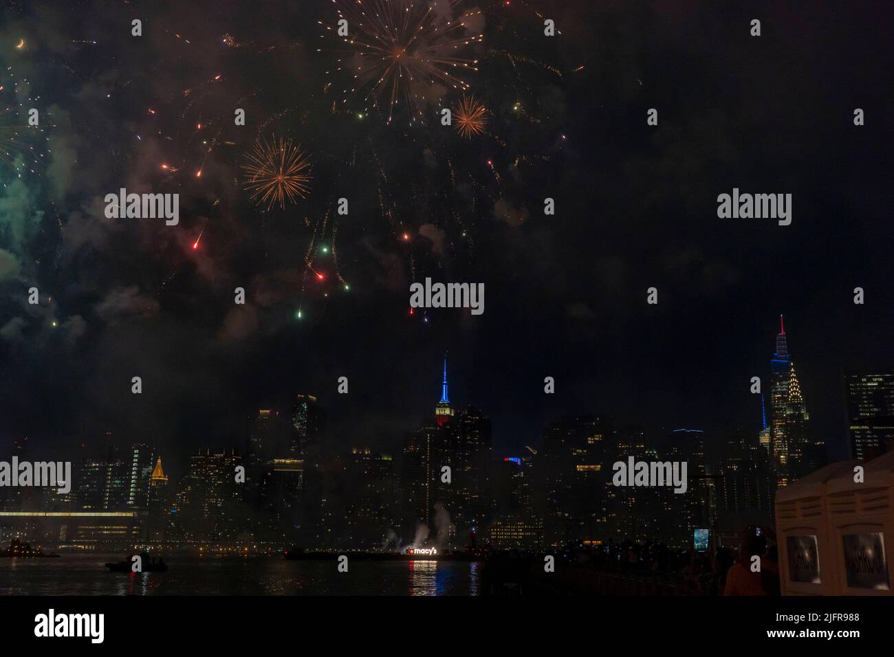 NEW YORK, NY - JULY 04: Fireworks explode over the east river during ...