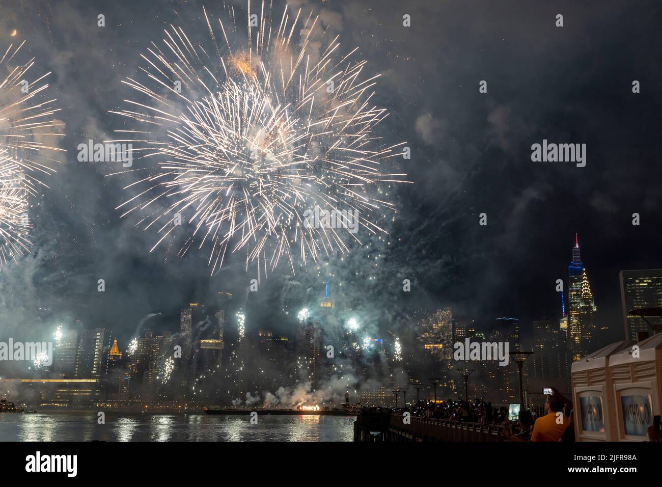 NEW YORK, NY - JULY 04: Fireworks explode over the east river during ...