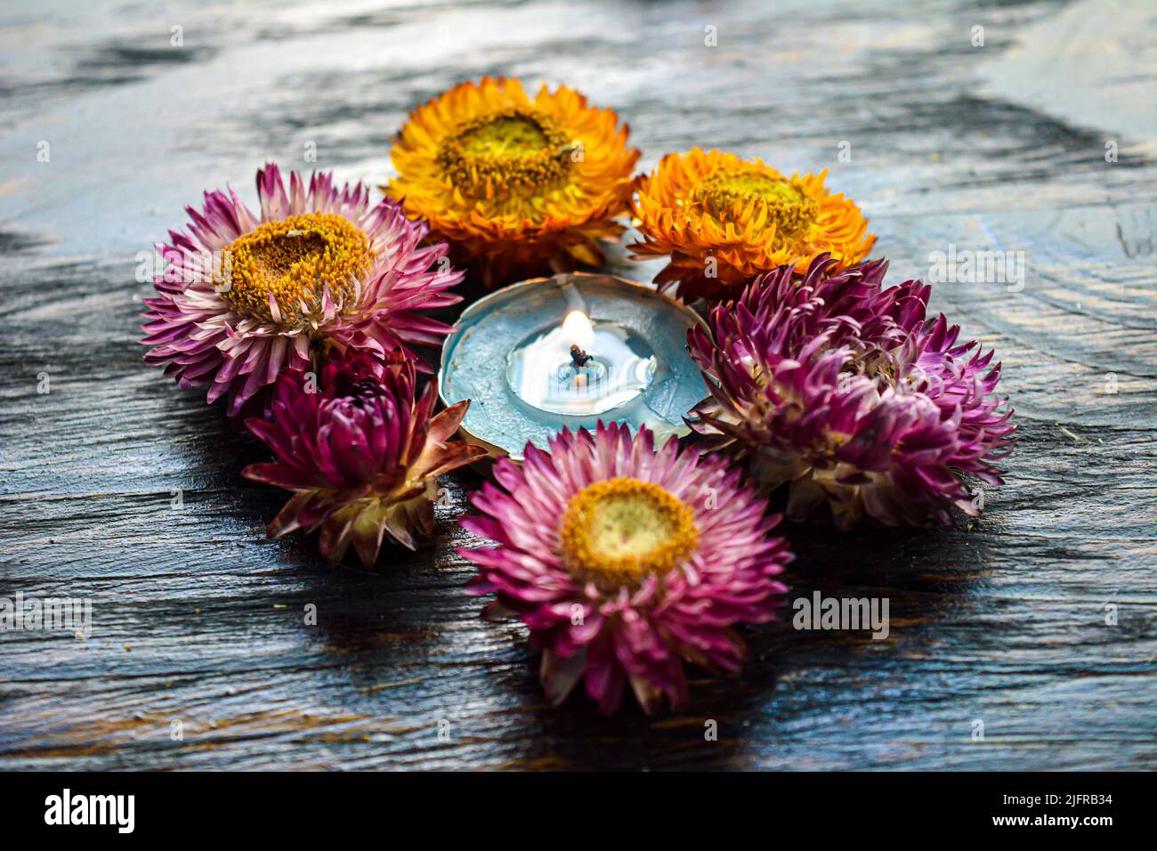 Burning candle on wooden background. Stock Photo
