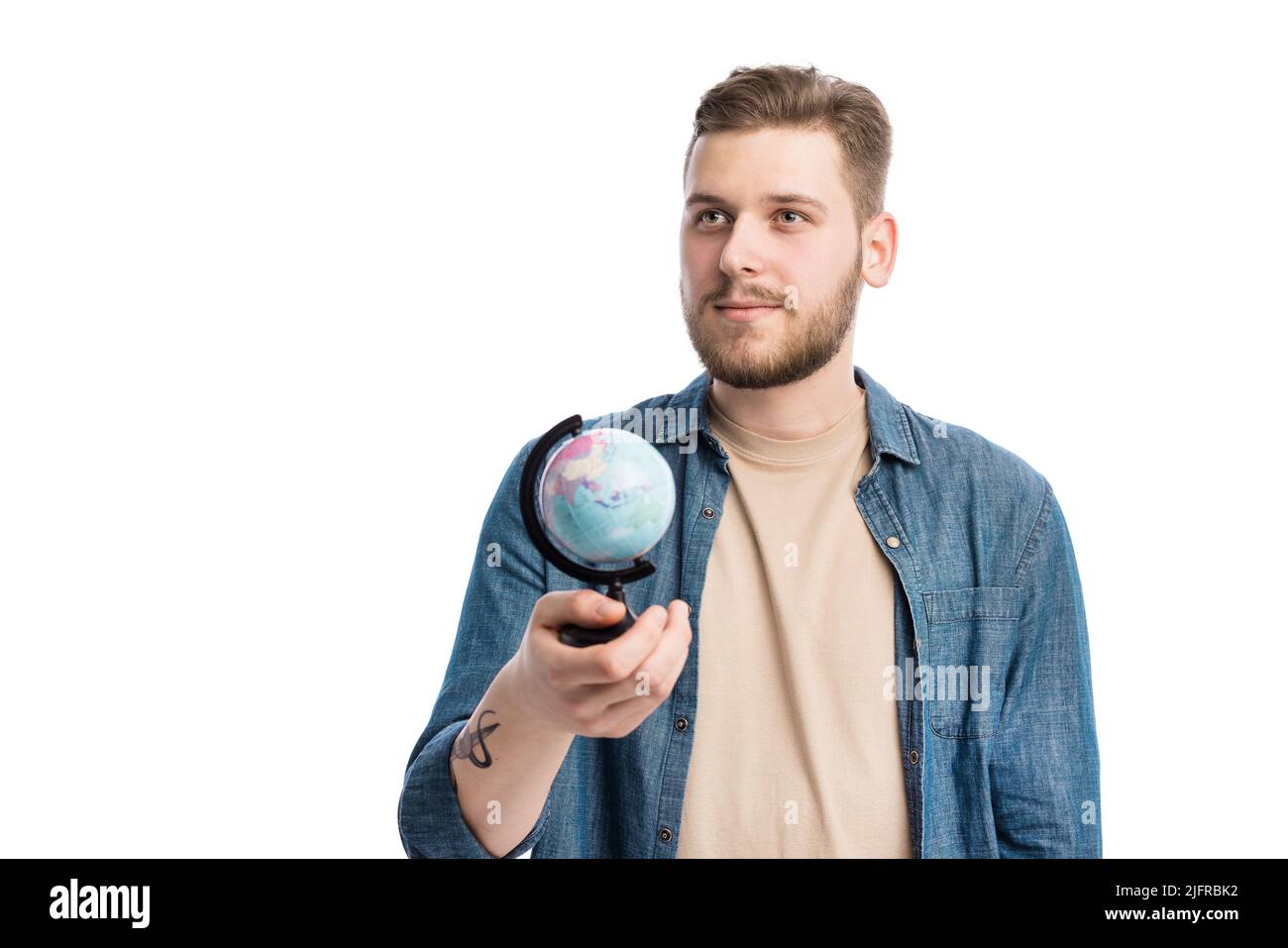 Thoughtful man holding globe Stock Photo