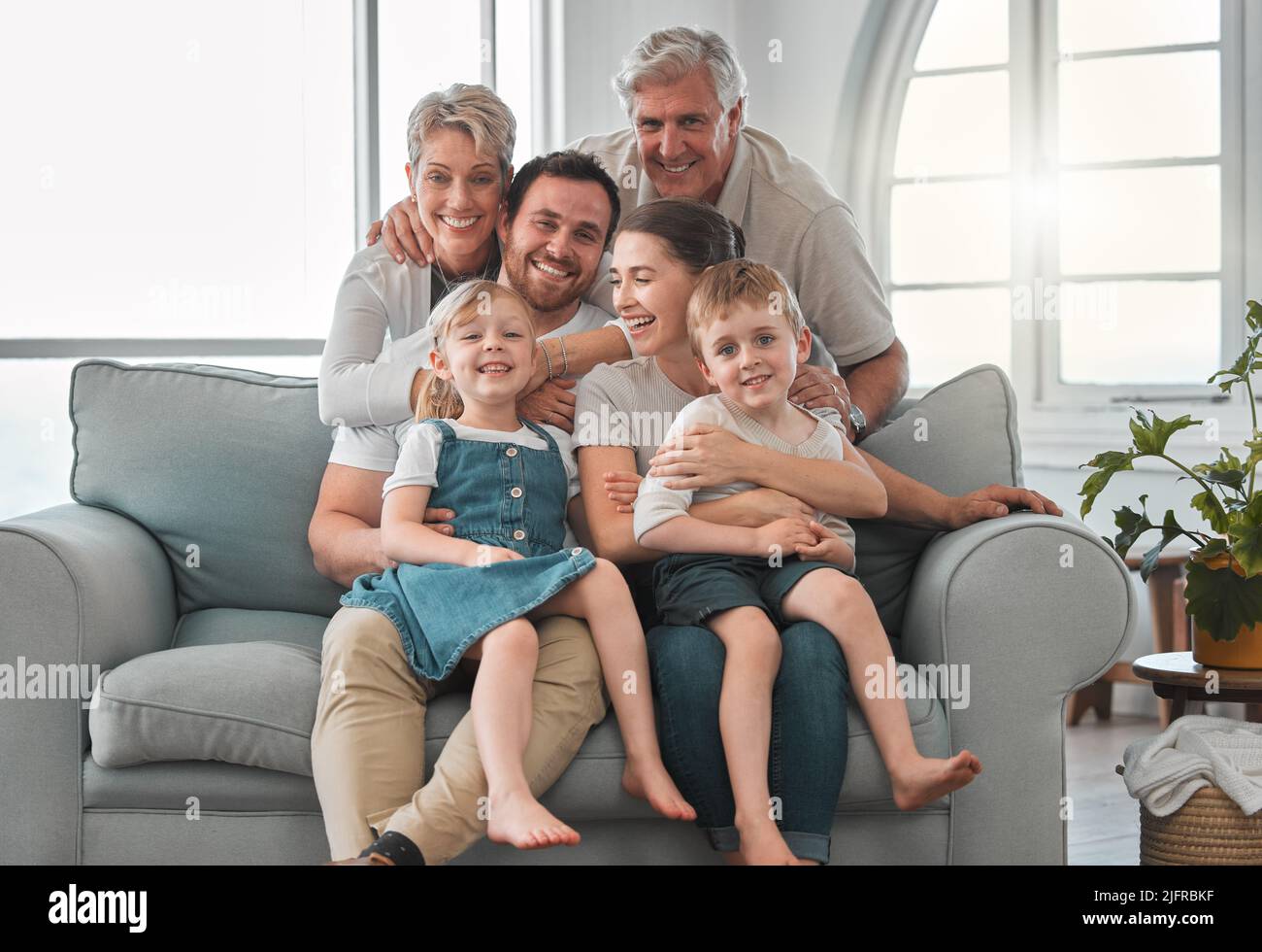 The memories we make with our family is everything. Shot of a happy family relaxing on the sofa at home. Stock Photo