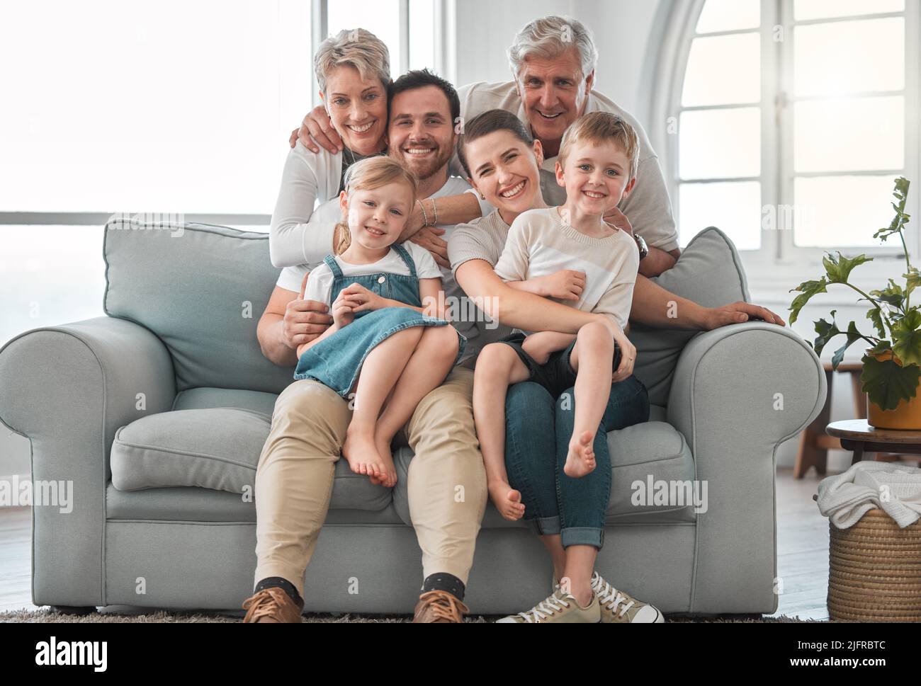 Live your life with love. Shot of a happy family relaxing on the sofa at home. Stock Photo
