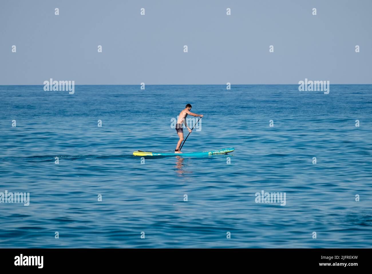 A young man on stand up paddleboard Stock Photo