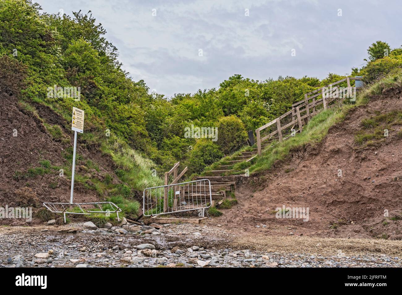 Thurstaston cliffs showing footpath stairs closed off after long period of heavy rain and tidal erosion from below causing colapses River Dee Estuary Stock Photo