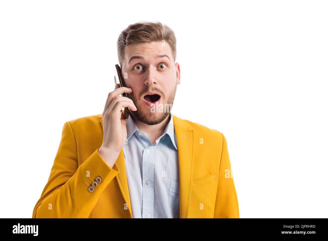 Surprised male talking on smartphone Stock Photo