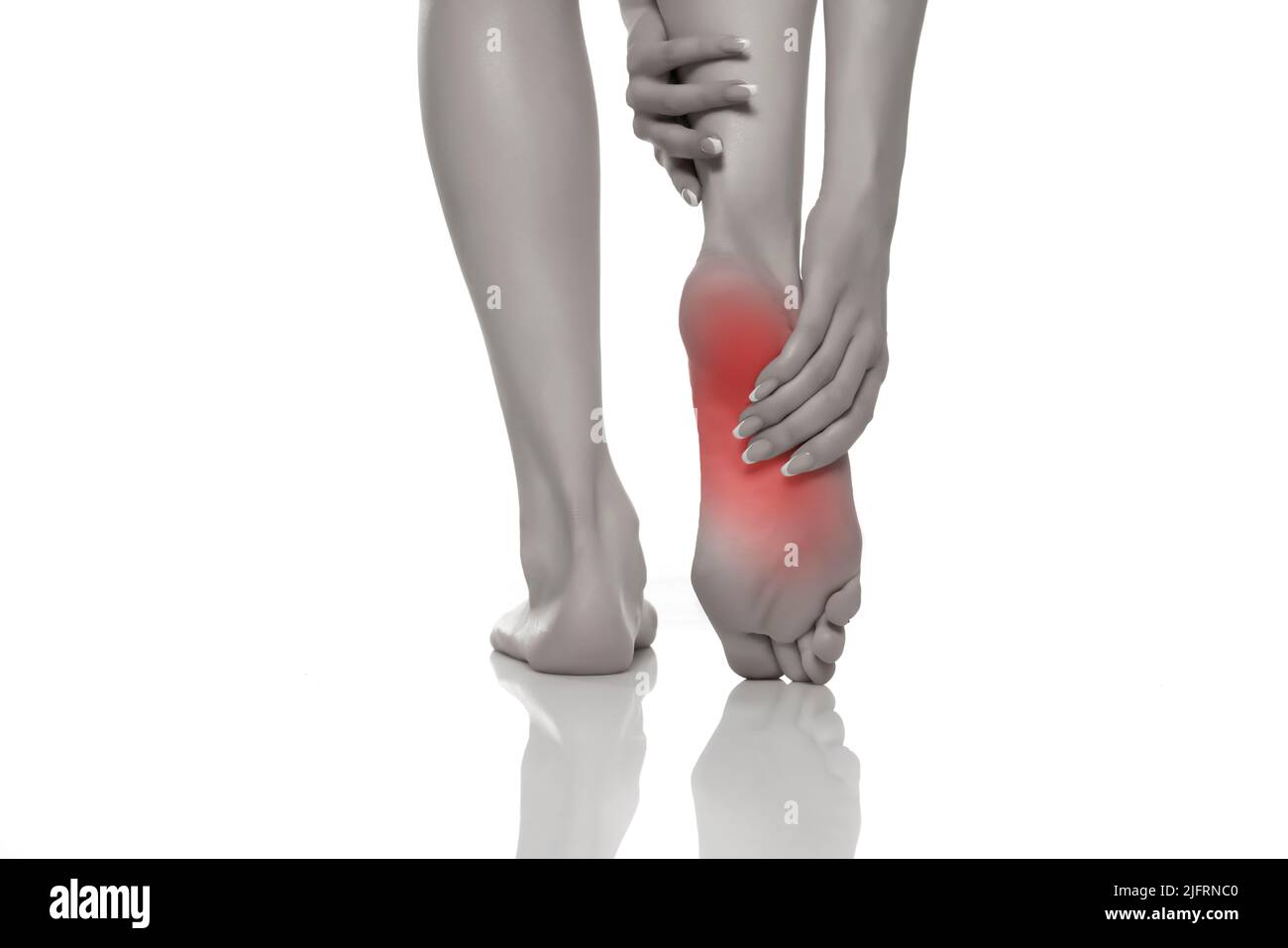 Foot pain in women on a white studio background. Pain concept. Stock Photo