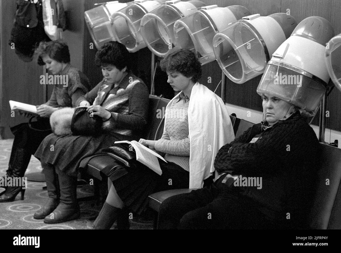 LADIES HAIRDRESSER in Moscow 1981Womam at the row of drying hoods in a hair salon Stock Photo