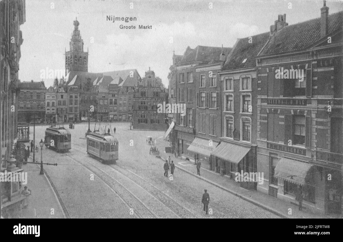 The face from the corner with the Broerstraat, with the facades of the west side of the Grote Markt, and the St. Stevenstoren in the background; To the right view of the Waaggebouw; in the foreground, right, the buildings on the north side, with two electric trams on the left Stock Photo