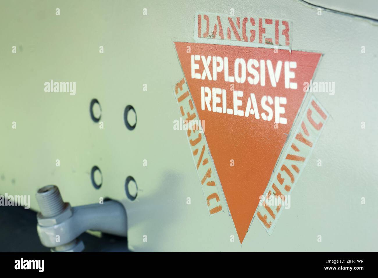 Danger Explosive Release, aircraft warning decal or sign on an old jet fighter airplane Stock Photo