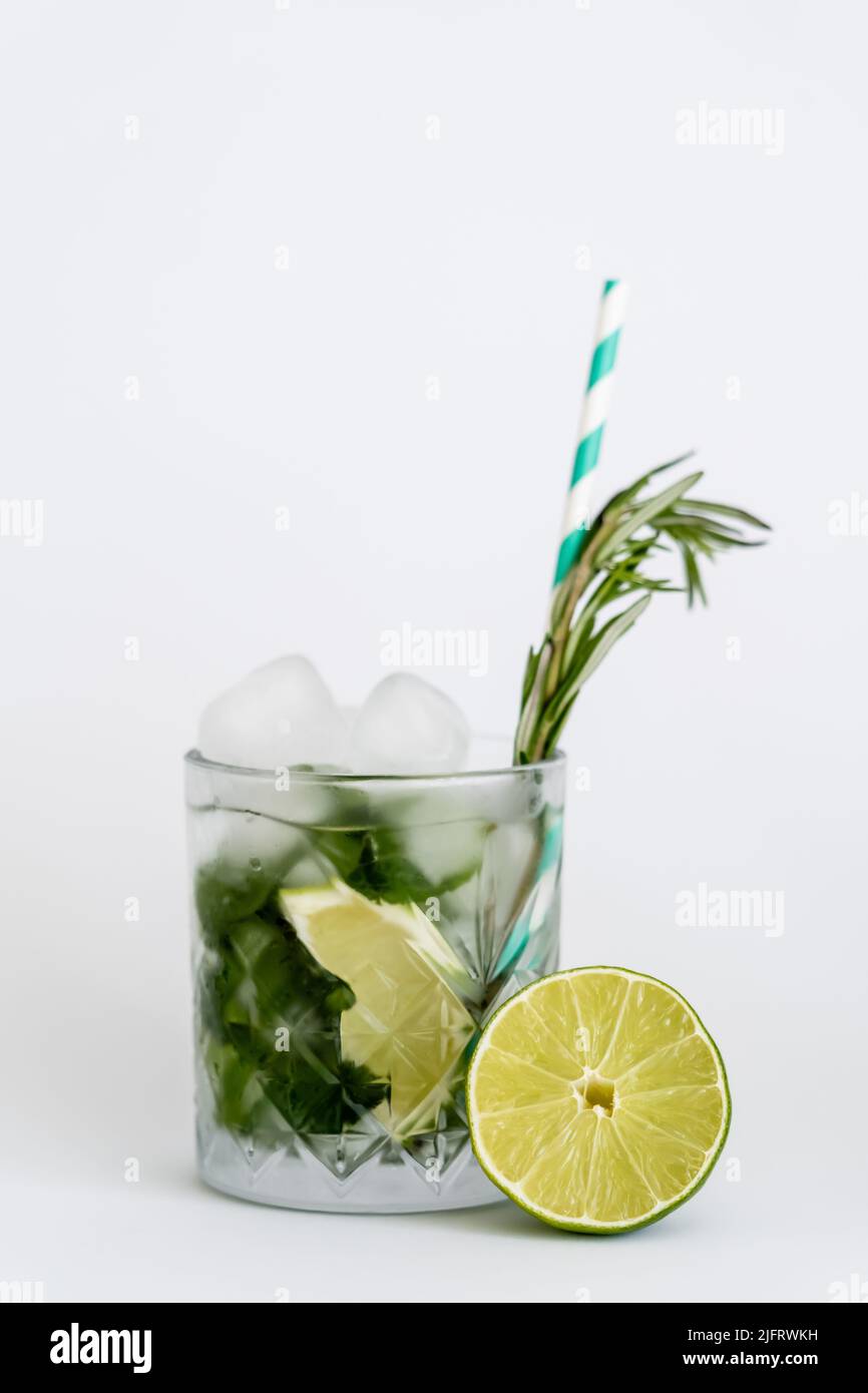 cool faceted glass with mojito, straw and ice cubes isolated on white Stock Photo