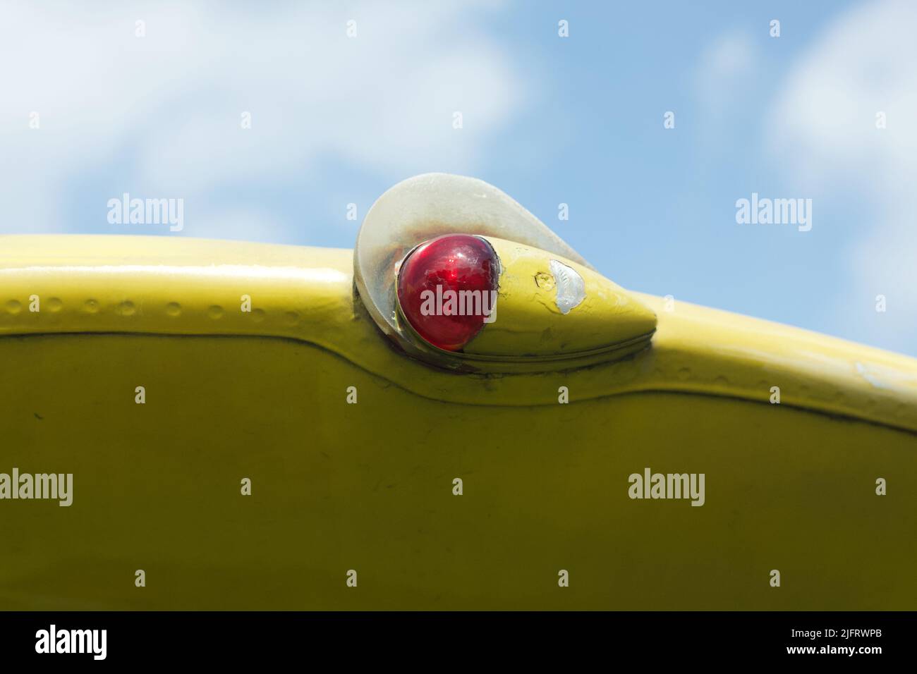 Red aviation navigation lights on yellow wing of an old aircraft Stock