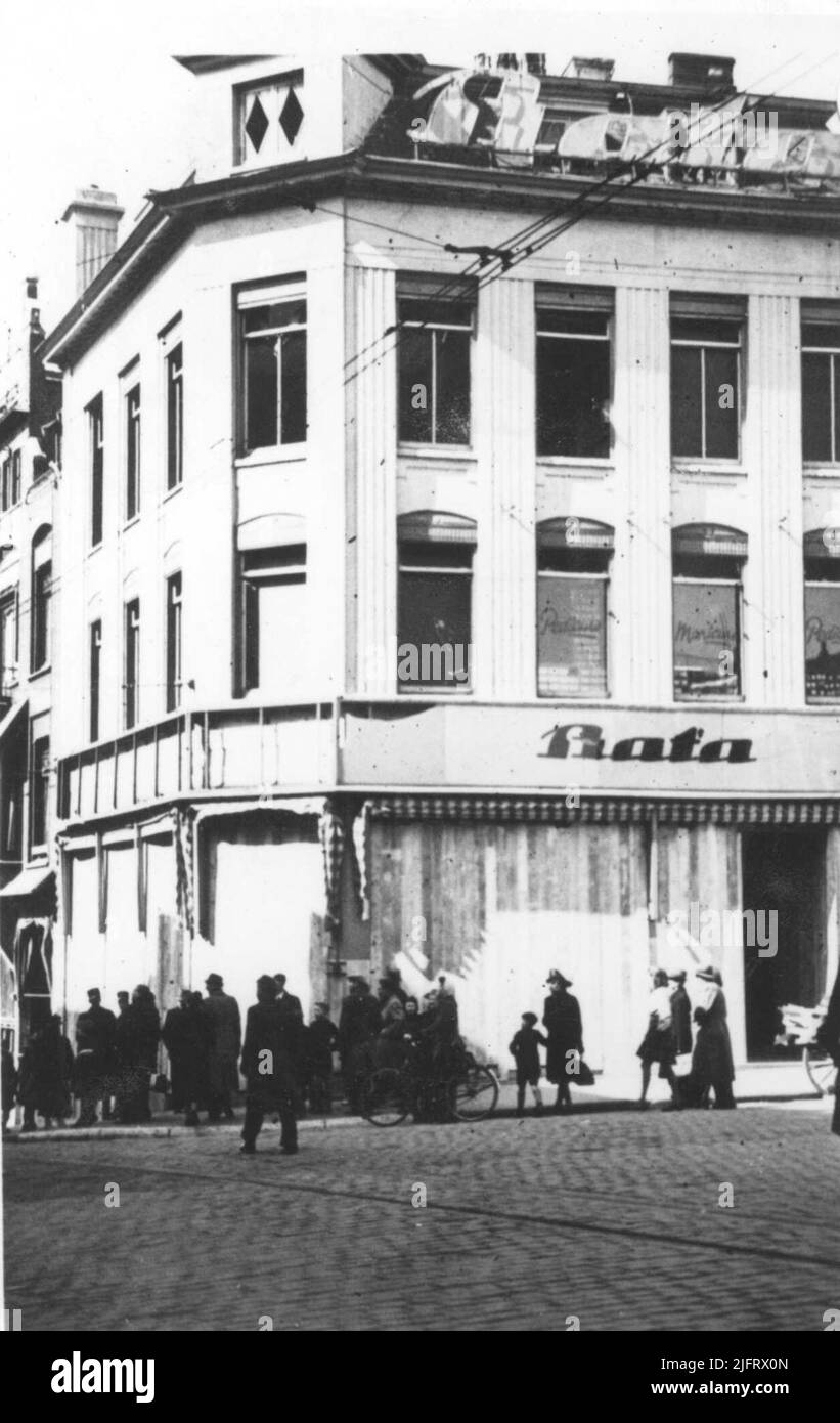 The building of the Bata, corner Stikke Hezelstraat Grote Markt after the bombing in the night of 26 to 27 March 1942. About the BATA: The shoe company was already founded in 1894 in, then still, Austria-Hungary (now Czech Republic). To against it At the beginning of the 1930s, BATA's world's largest shoe exporter was BATA. In 1939 Bata owned 63 companies with an annual sale of more than 60 million pairs of shoes in more than 30 countries. Around 1942, 105,770 people worked at the group. The technological developments of the company, however, lagged behind and it went bankrupt in 2000. Stock Photo