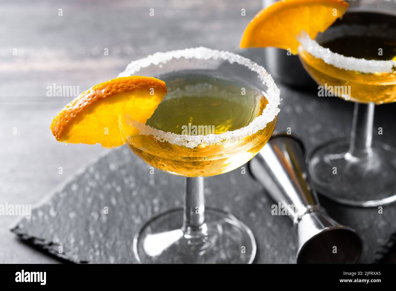 Sidecar cocktail with a sugar rim on wooden table Stock Photo