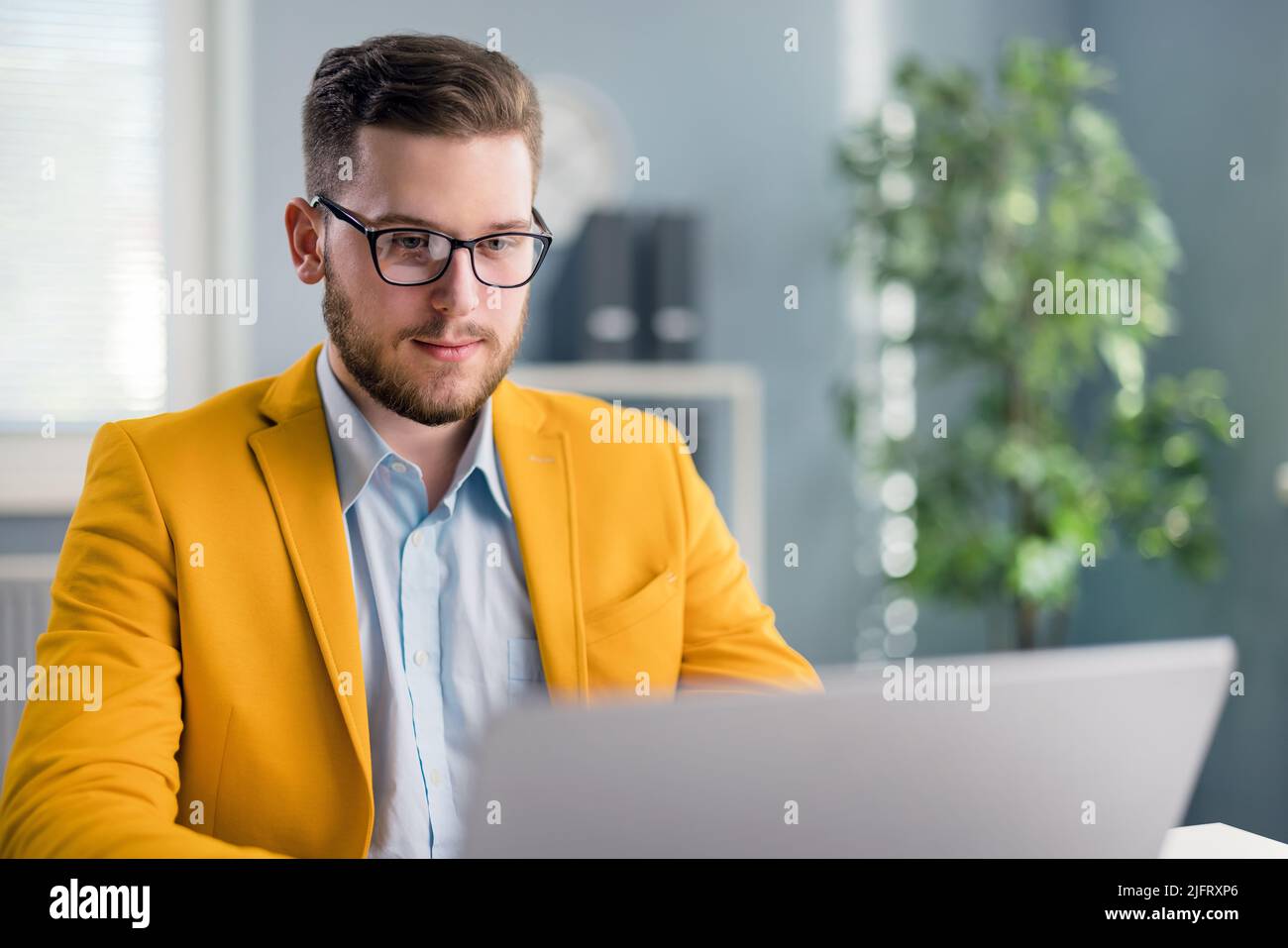 Positive businessman working online Stock Photo