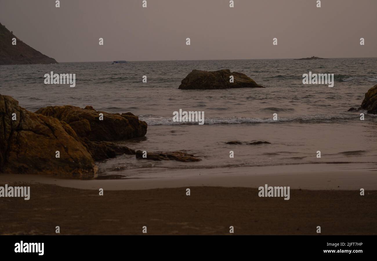 gokarna om beach at sunset. waves calming down. Stock Photo