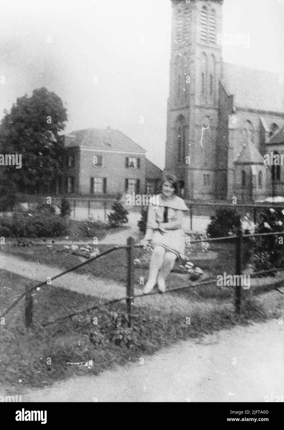 Mary Barends (daughter of the owner of Café 't Molentje) with the R.K. church Stock Photo