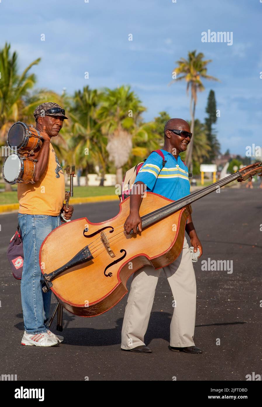 Cuba, Varadero, two members of a music band are going home with their  instruments Stock Photo - Alamy