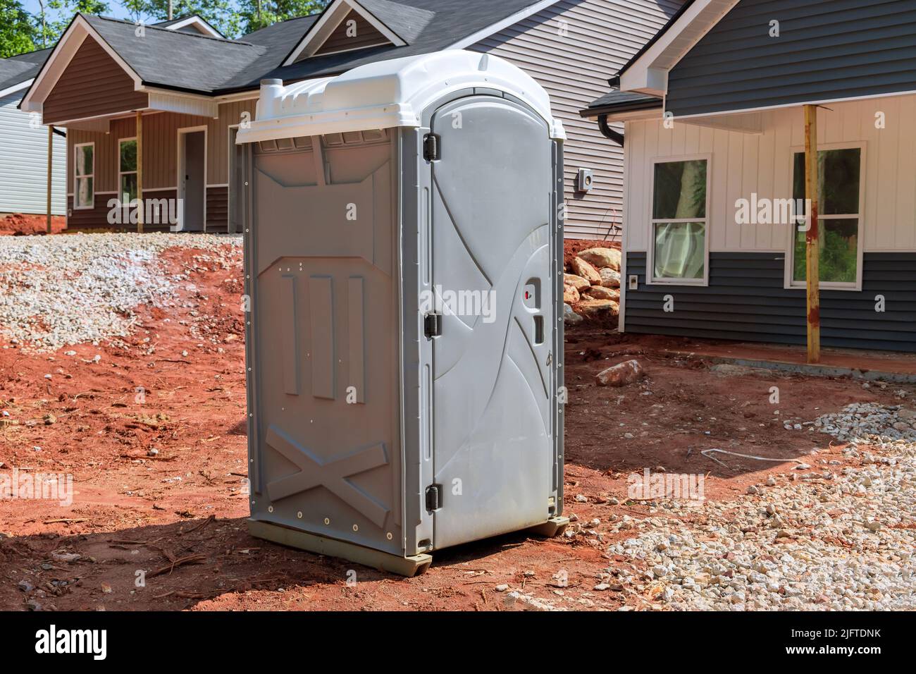 The portable restroom on the construction site of a house under construction Stock Photo