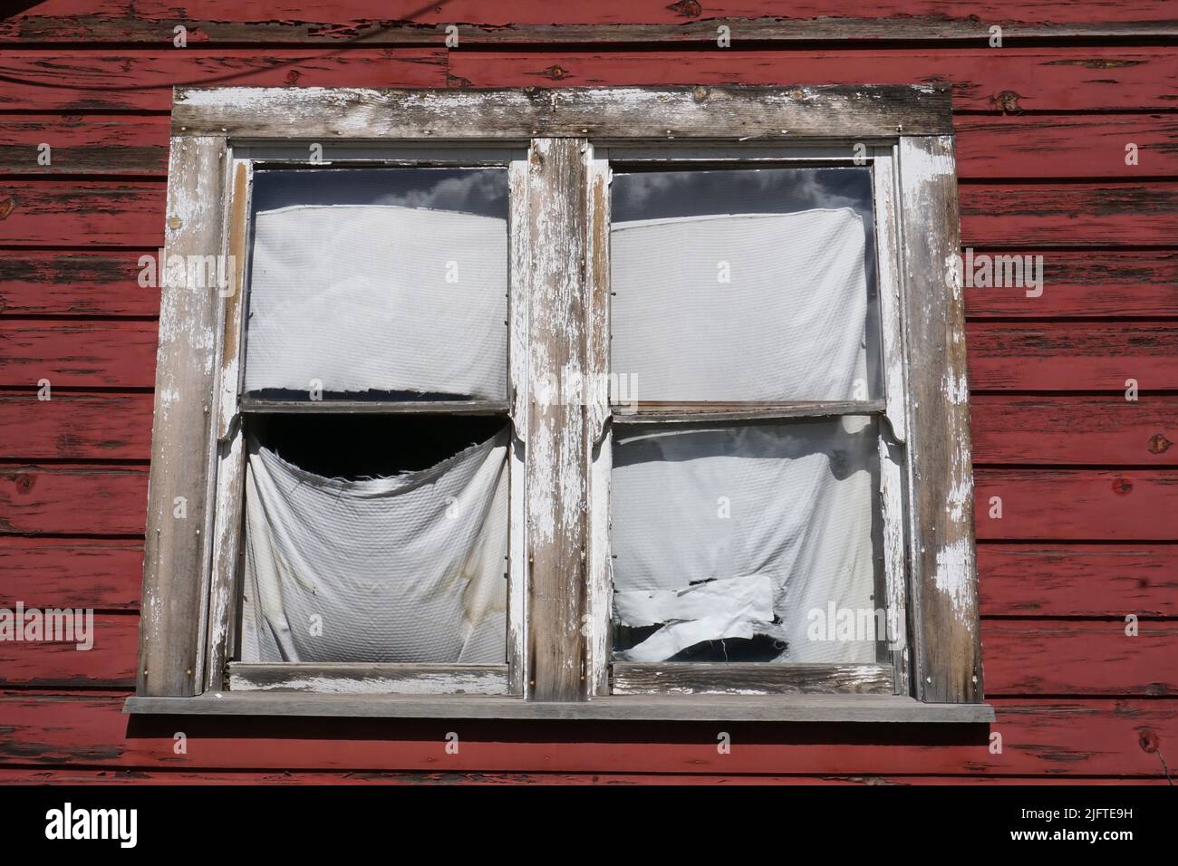 An old window with peeling paint Stock Photo