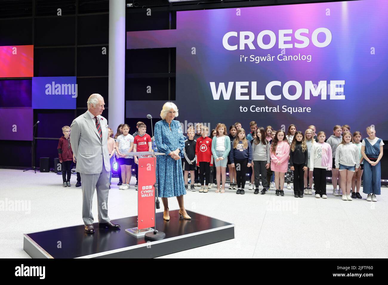 The Prince of Wales and the Duchess of Cornwall in the Atrium with children and members of the Urdd from Ysgol Talsarnau and Ysgol Cefn Coch in Gwynedd during a visit to BBC Wales's new headquarters in Cardiff for the launch of the broadcaster's public tours. Picture date: Tuesday July 5, 2022. Stock Photo