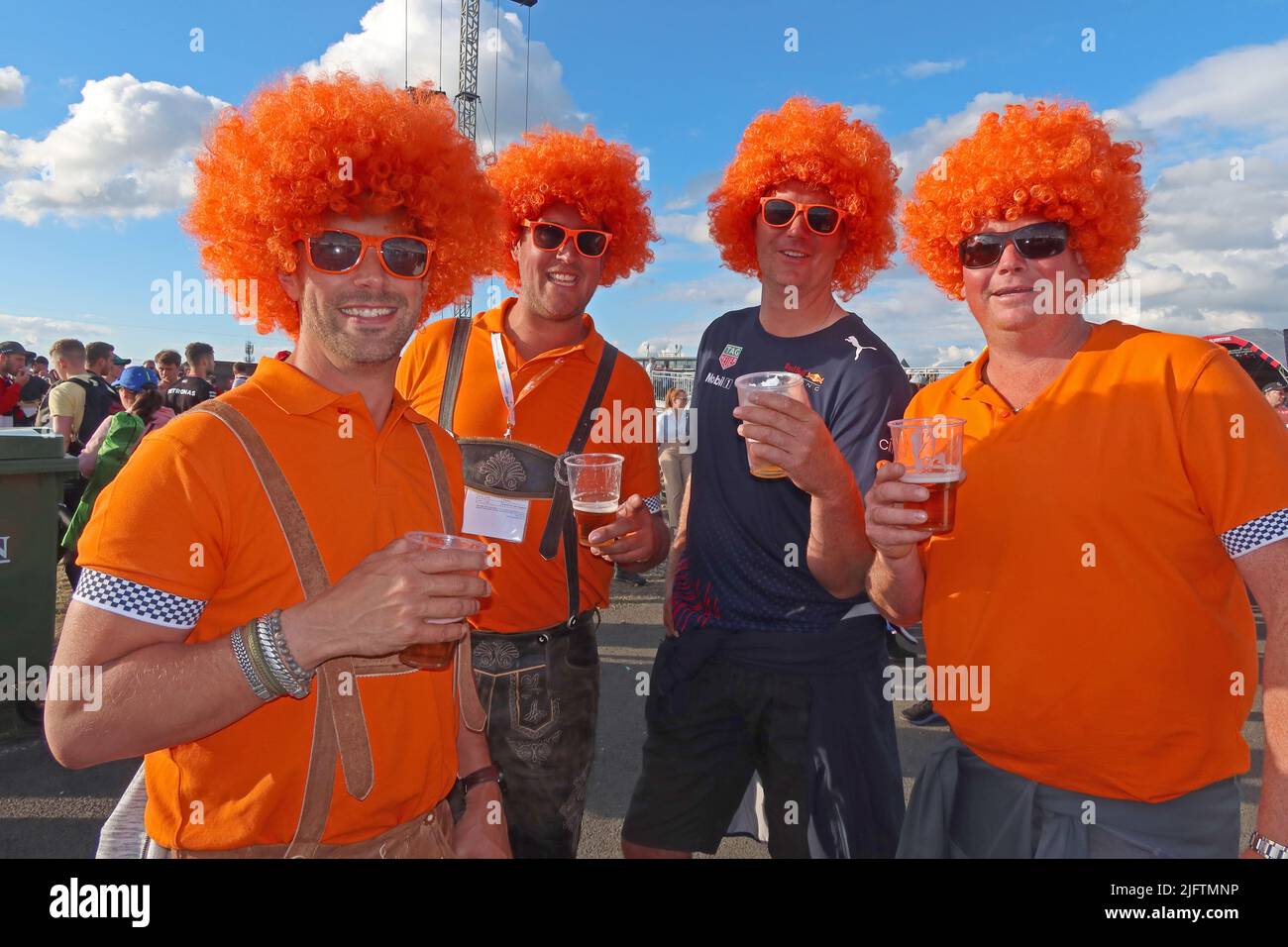 Silverstone Max Verstappen, Red Bull racing fans, in orange tops and wigs , F1 Grand Prix 2022, England, UK Stock Photo