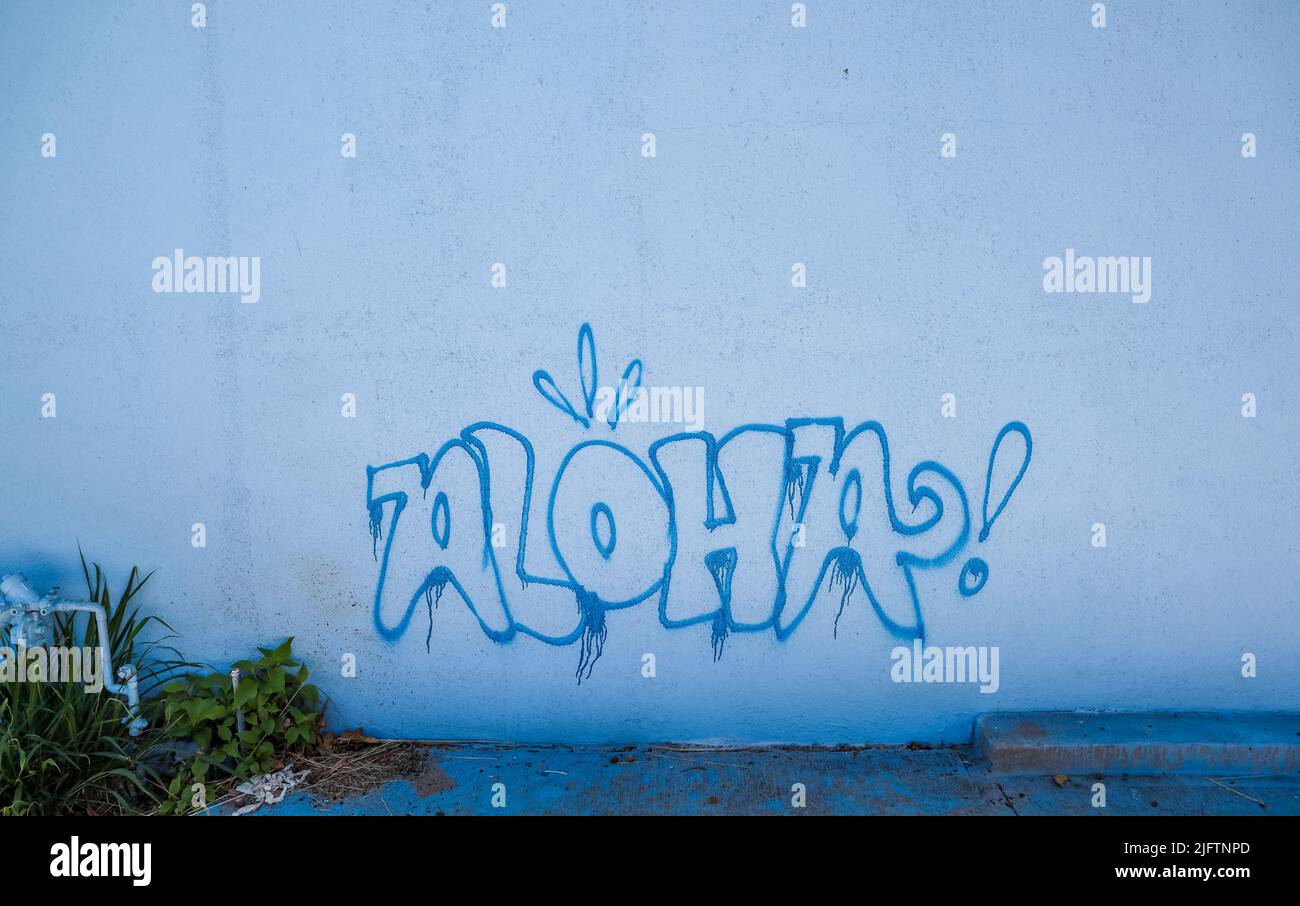 A Grafitti Aloha welcome hello sign on an outdoor wall Stock Photo