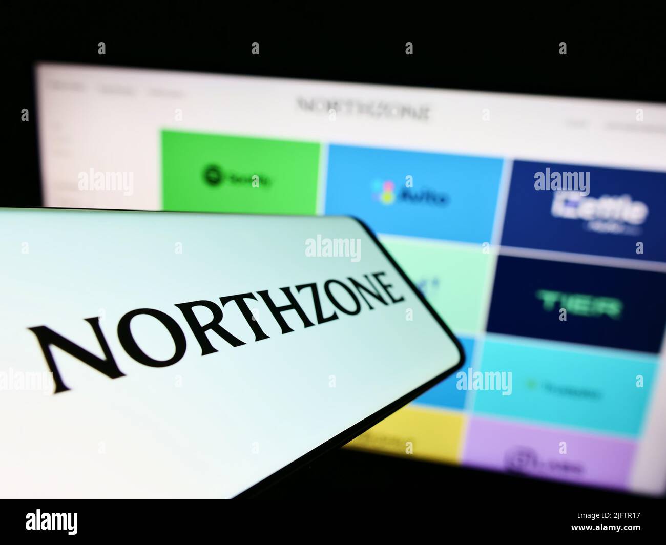 Cellphone with logo of British venture capital company Northzone on screen in front of business website. Focus on center of phone display. Stock Photo