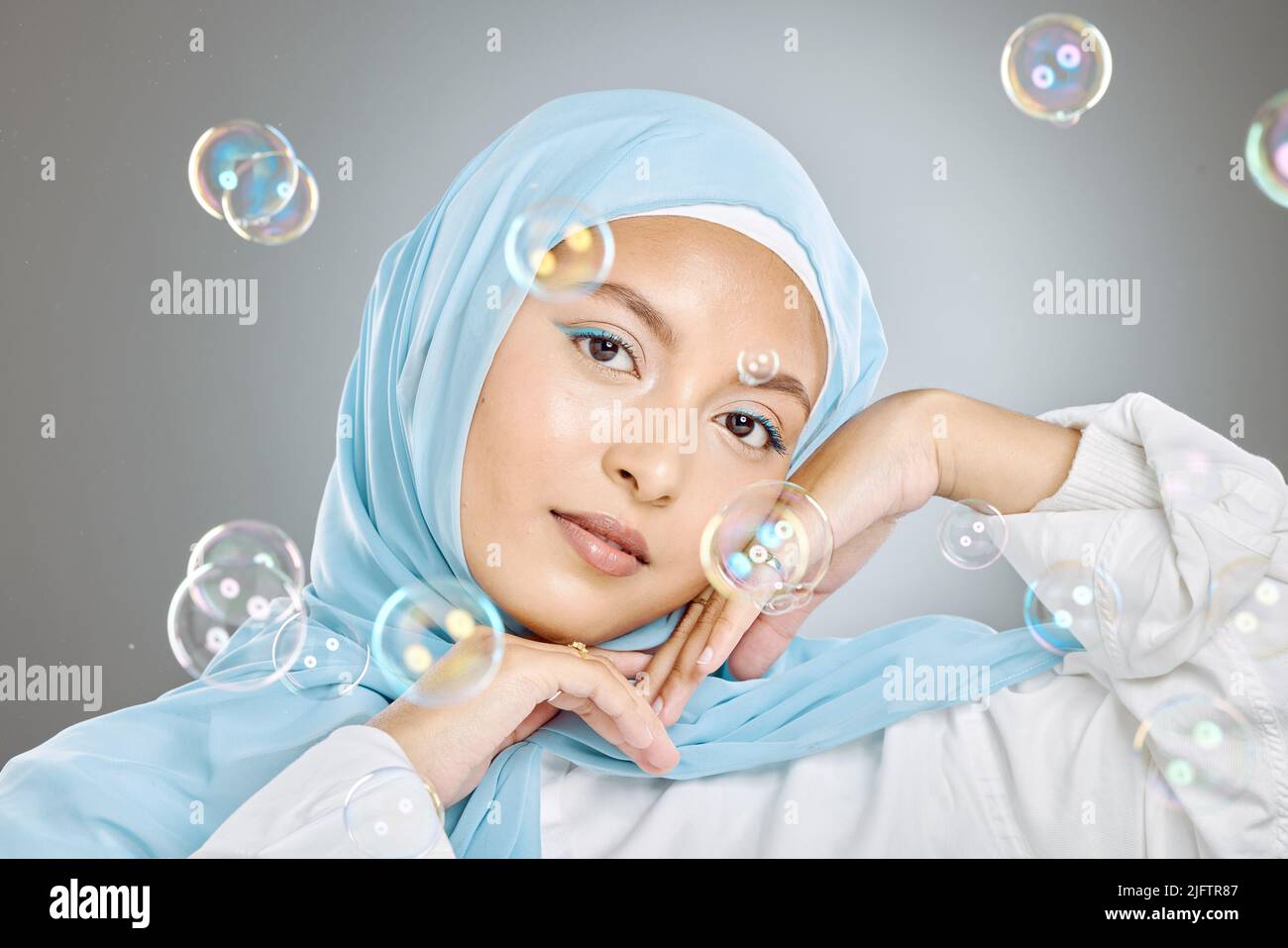 Portrait of a beautiful muslim woman wearing blue hijab headscarf ...