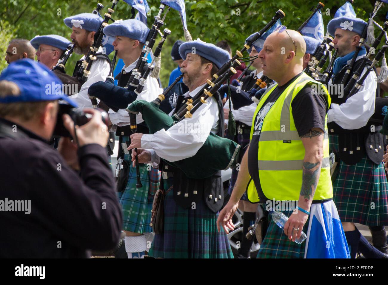 March for Independent Scotland, Bag Pipes Players in Kilt in Crowd Stock Photo