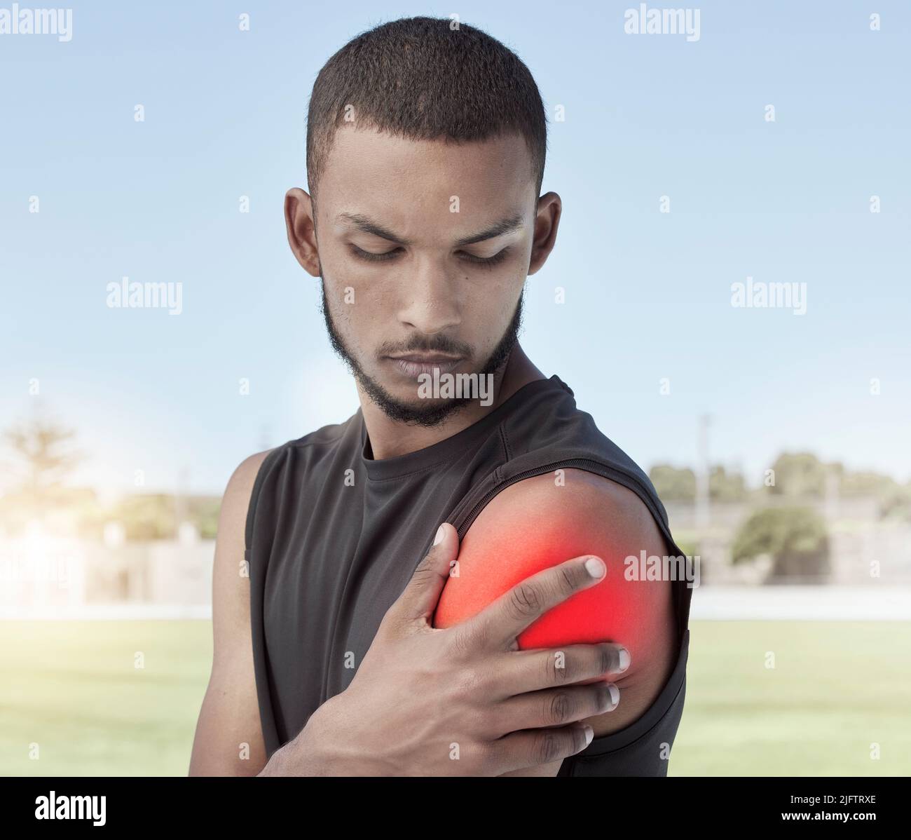 Closeup of an athlete with shoulder pain after a workout. Side profile of a young sportsman