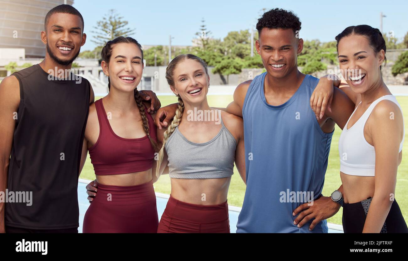 Portrait of diverse group of athletes standing together and smiling after practice. Young, happy, fit, active sports team bonding in training sports Stock Photo