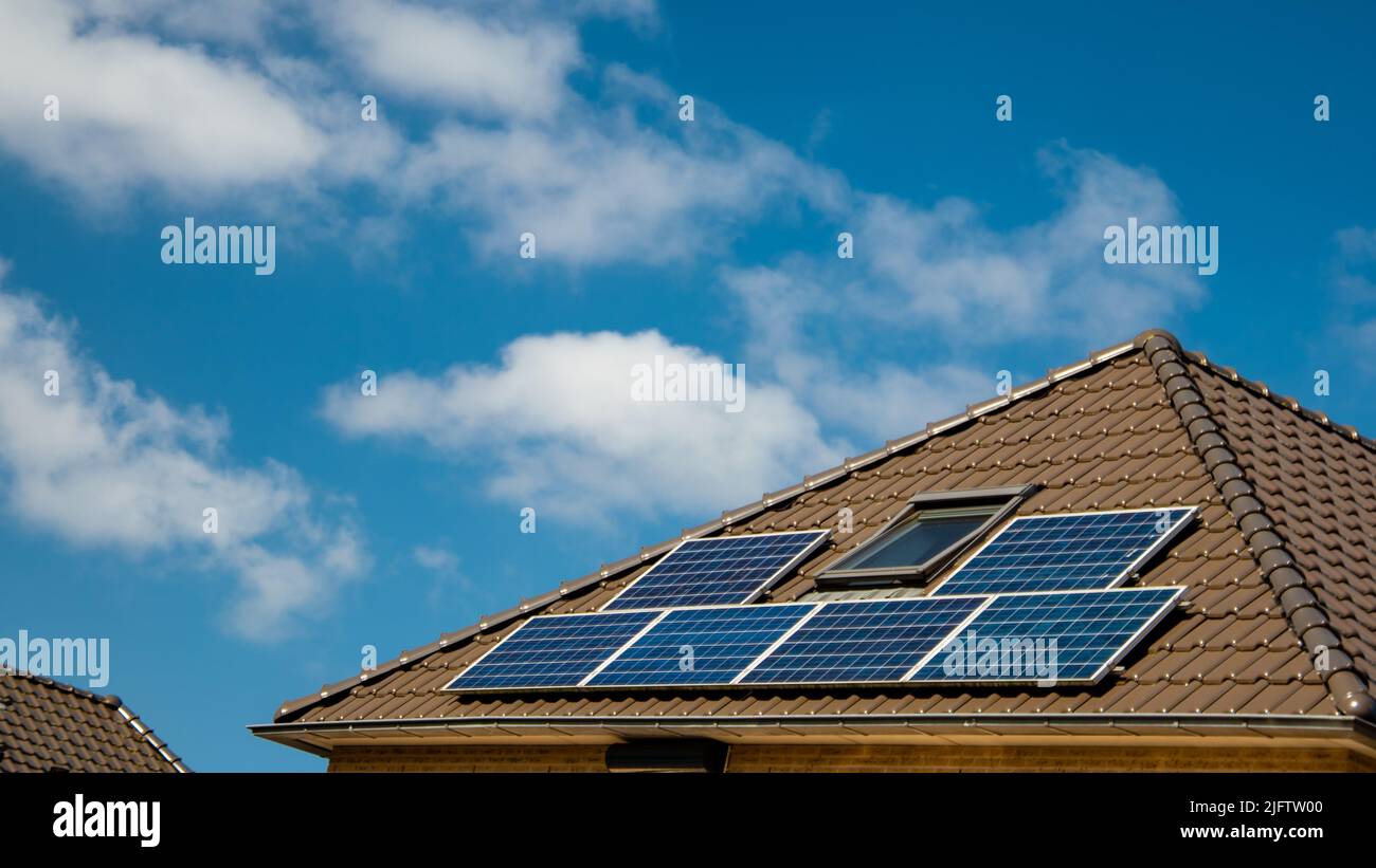 Newly build houses with solar panels attached on the roof against a sunny sky Close up of new