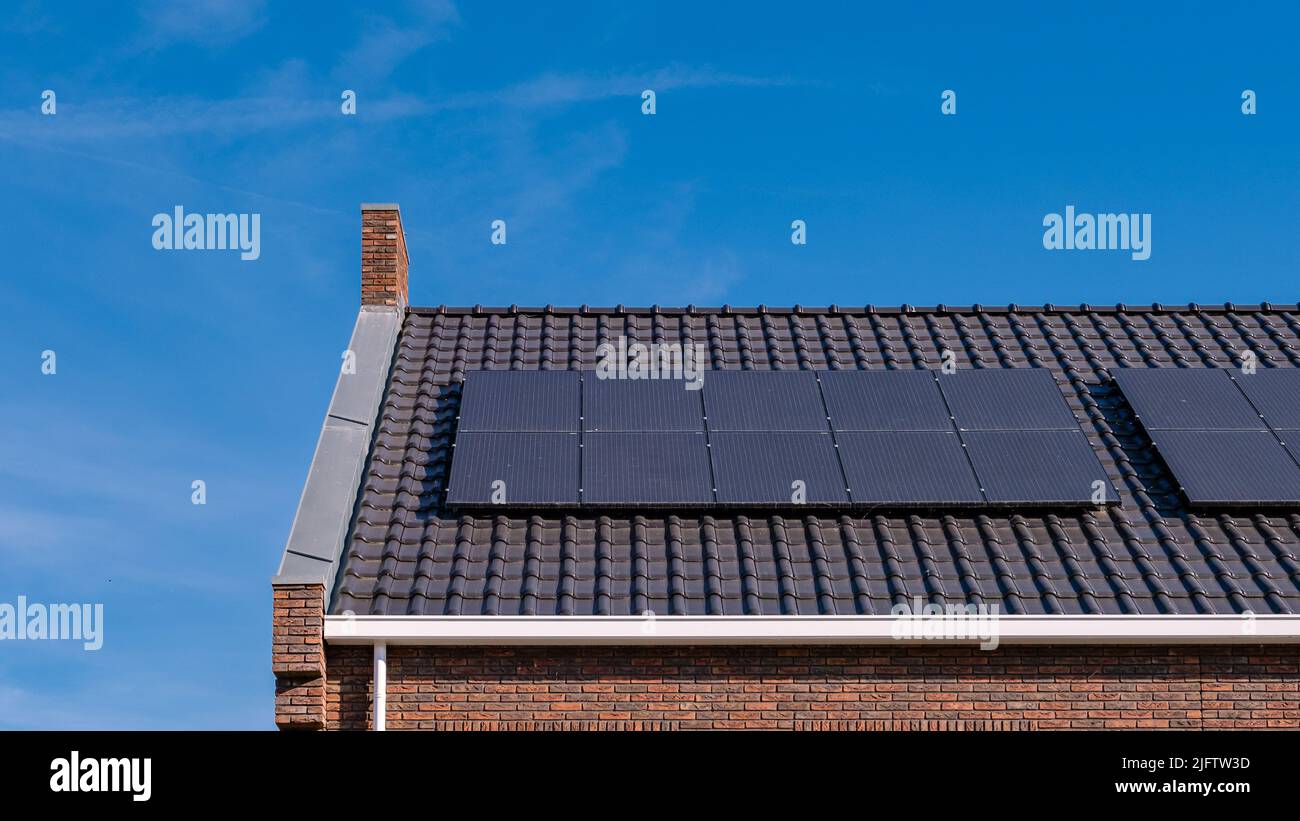 Newly build houses with solar panels attached on the roof against a