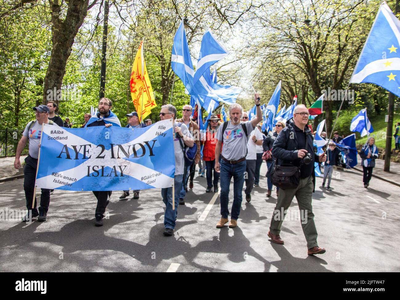 March for Indyref 2, People with Scottish Flags and Banner 'Aye 2Indy Islay' Stock Photo
