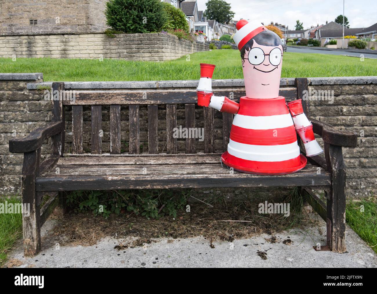 Colourful character  seated in Ingfield Lane Settle BD24.  Settle Flowerpot Festival 2022, Yorkshire Dales National Park. Stock Photo