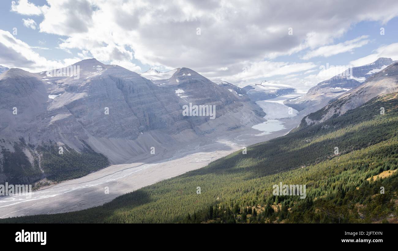 Beautiful pristine alpine valley surrounded by mountains and with glacier on its end, Jasper, Canada Stock Photo