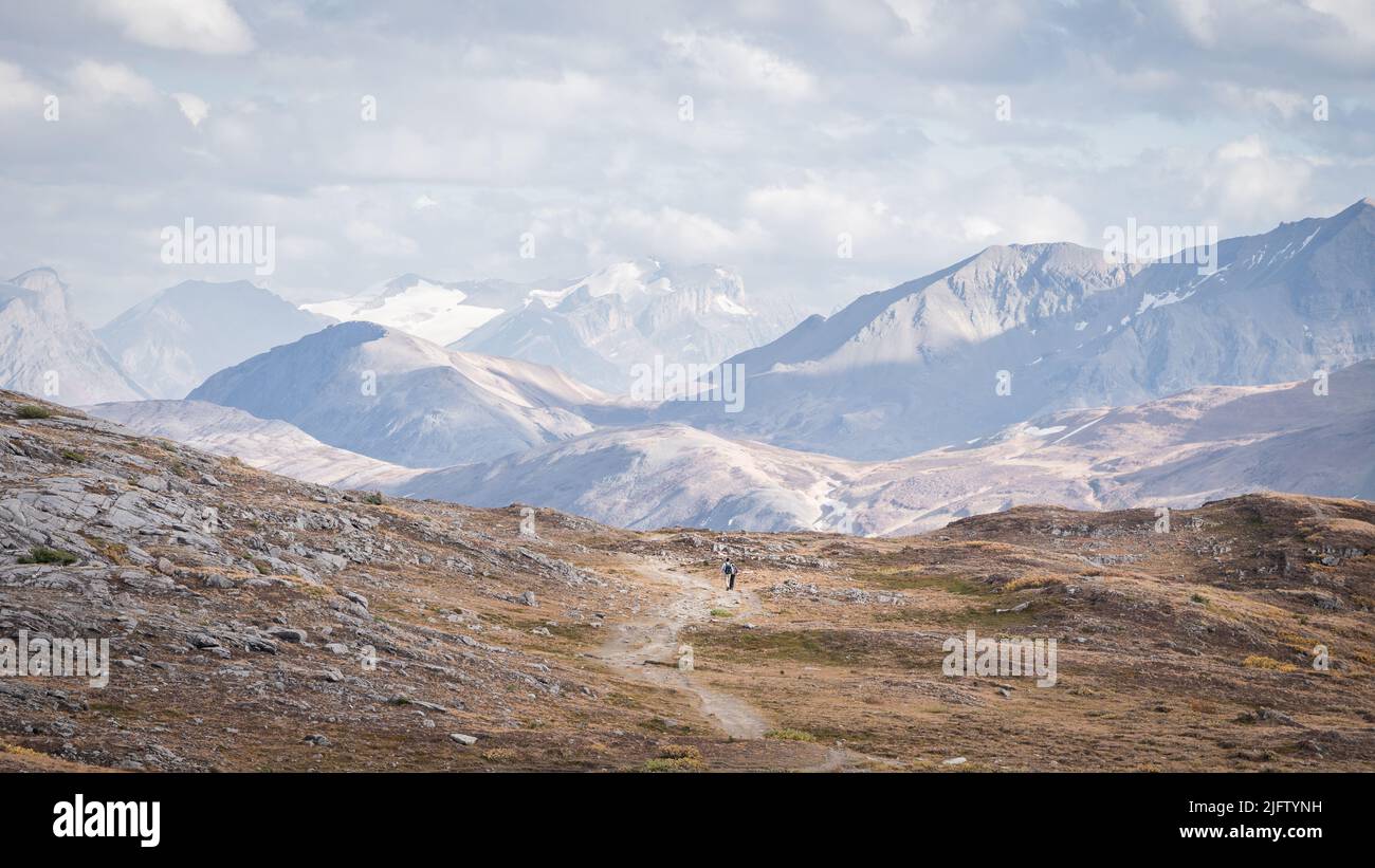 Hikers walking through stunning alpine valley in Canadian Rockies during fall,Jasper N.Park,Canada Stock Photo