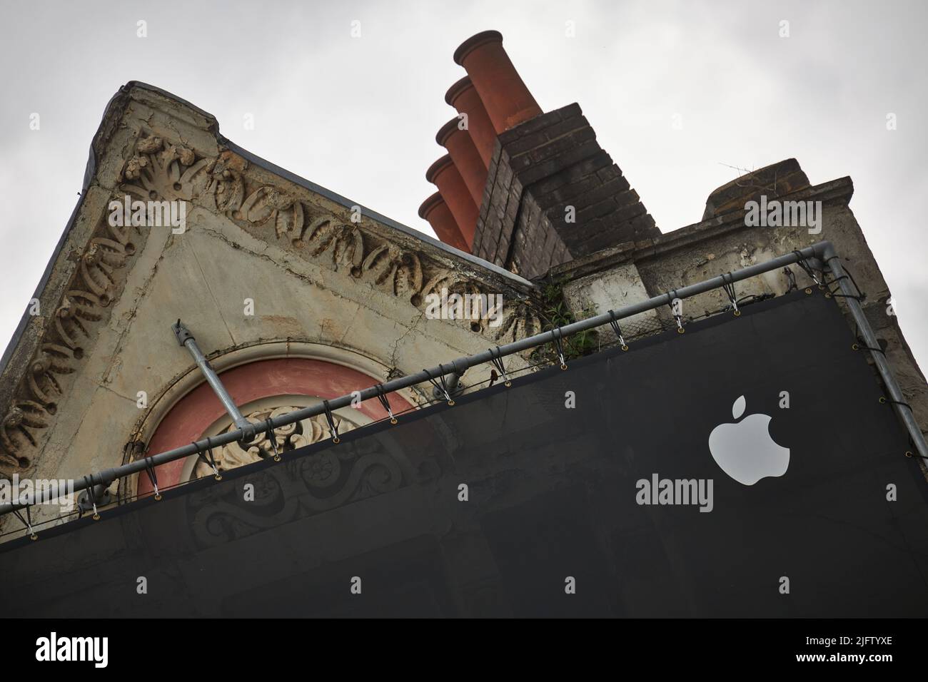 Modern Apple advert covering traditional London building. Stock Photo