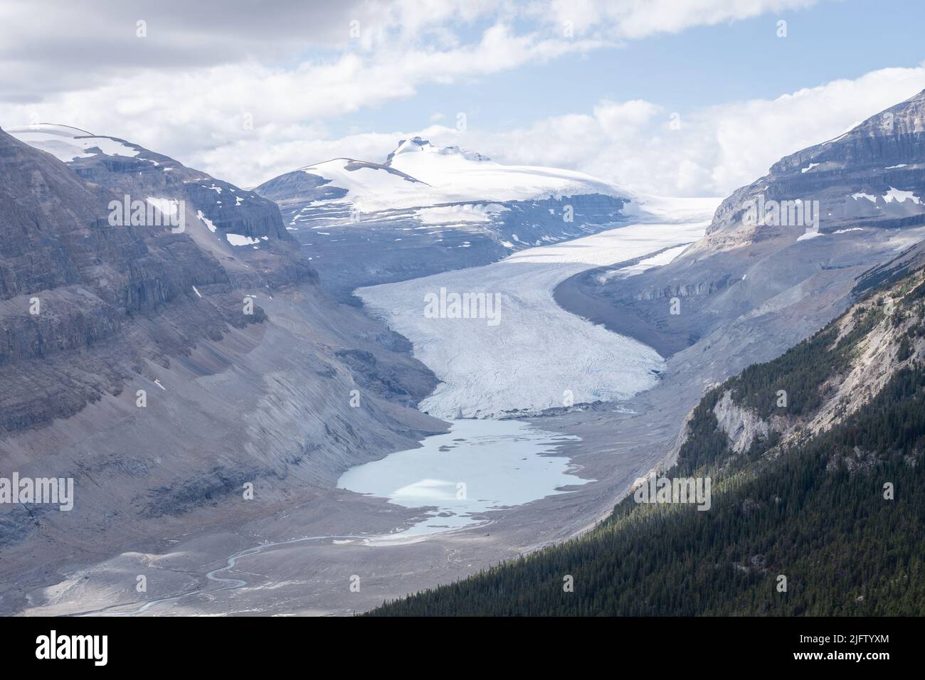 Massive melting glacier with glacial pool on its bottom, horizontal shot, Jasper, Canada Stock Photo