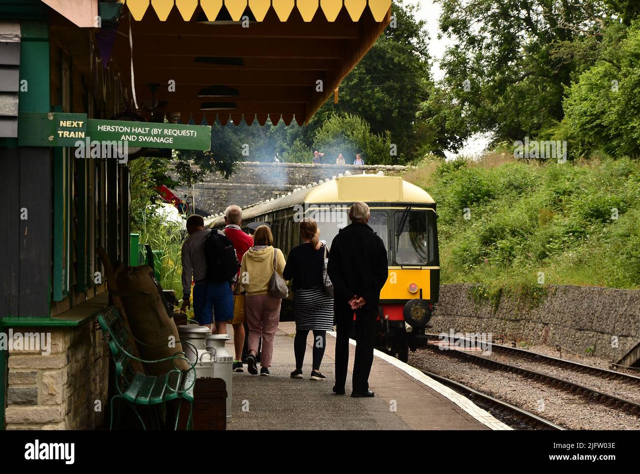 Diesel passenger train departing Harman's Cross station on the Swanage steam railway, Dorset, UK Stock Photo