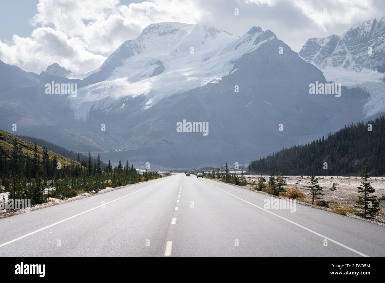 Alpine highway leading to the massive mountain with snow and glaciers, Jasper, Canada Stock Photo