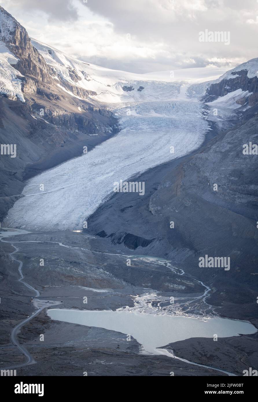 Massive melting glacier with glacial pool on its bottom, vertical shot, Jasper, Canada Stock Photo