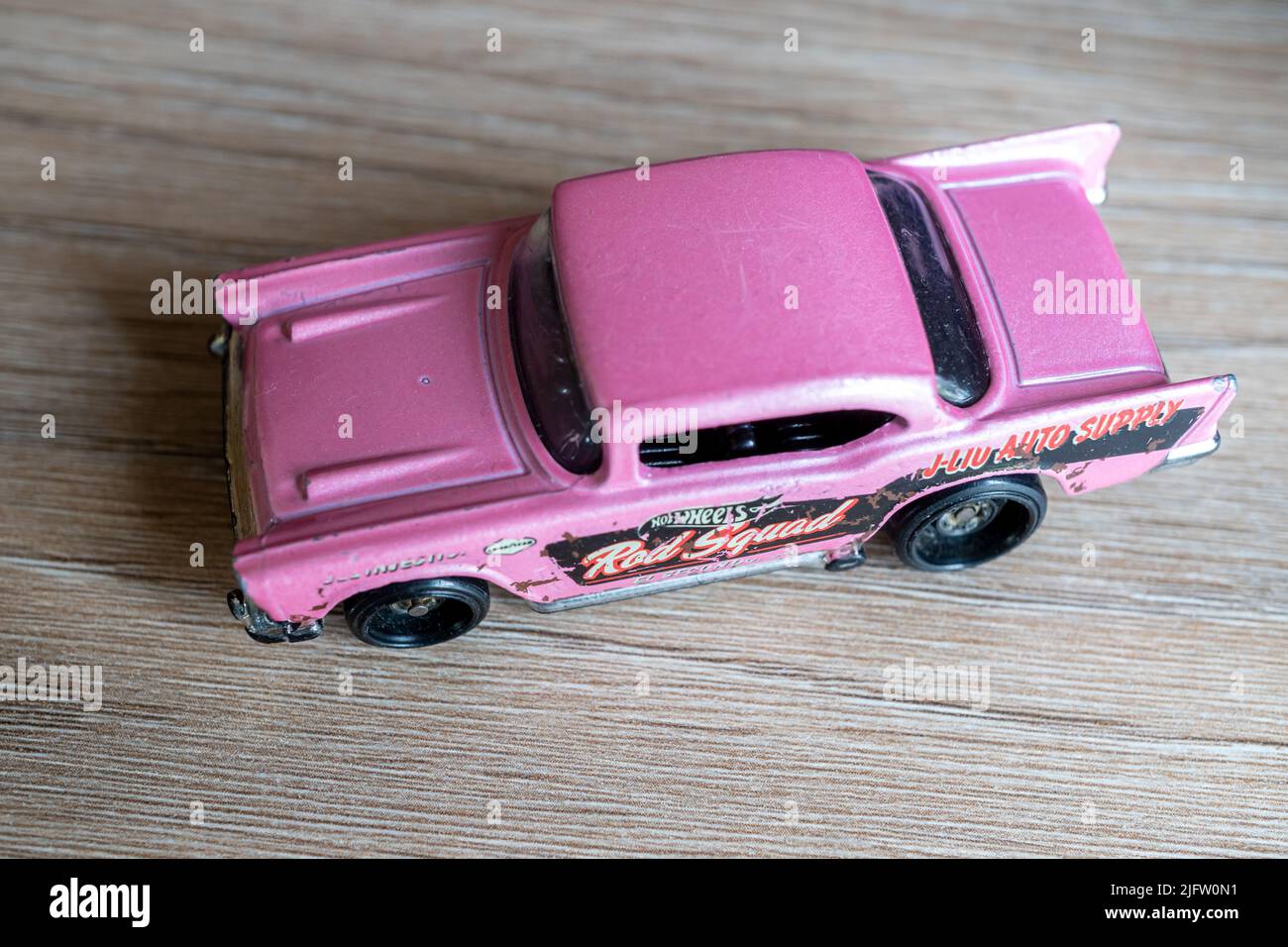 A high-angle closeup of a Mattel Hot Wheels pink-colored classic toy ...