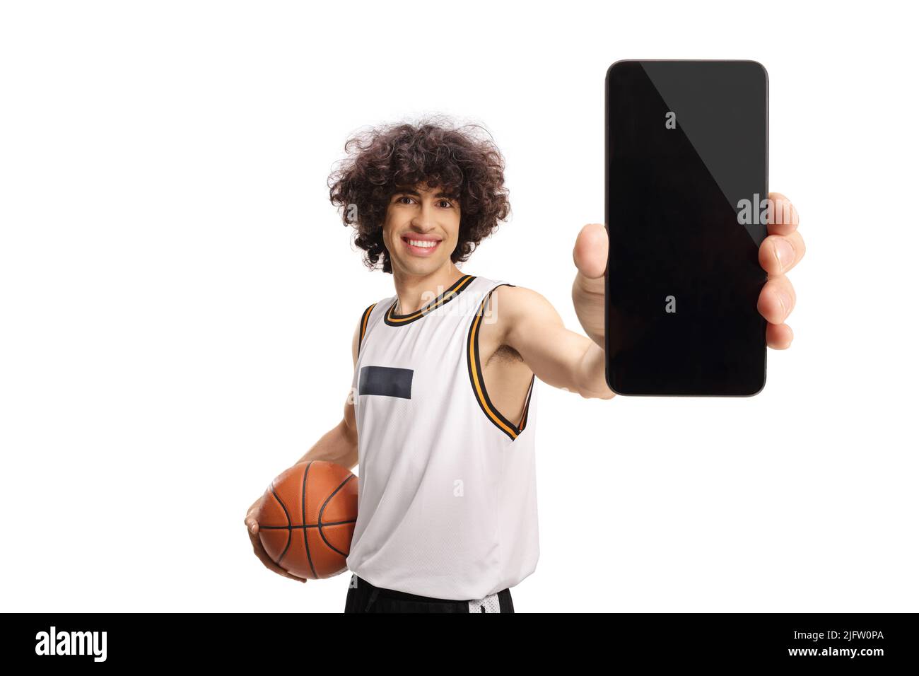 Basketball player holding a ball and showing a smartphone isolated on white background Stock Photo