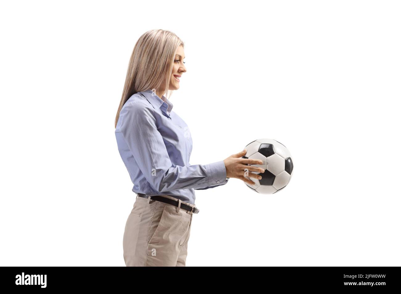 Profile shot of a woman in formal clothes holding a football isolated on white background Stock Photo