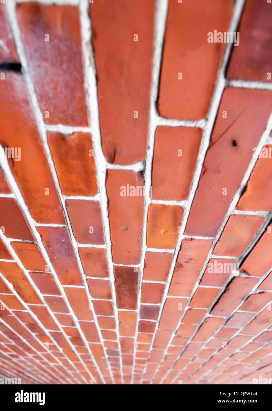 Perspective closeup of a red brick wall, copy space on home exterior, house or city building. Texture and detail background of strong, solid Stock Photo