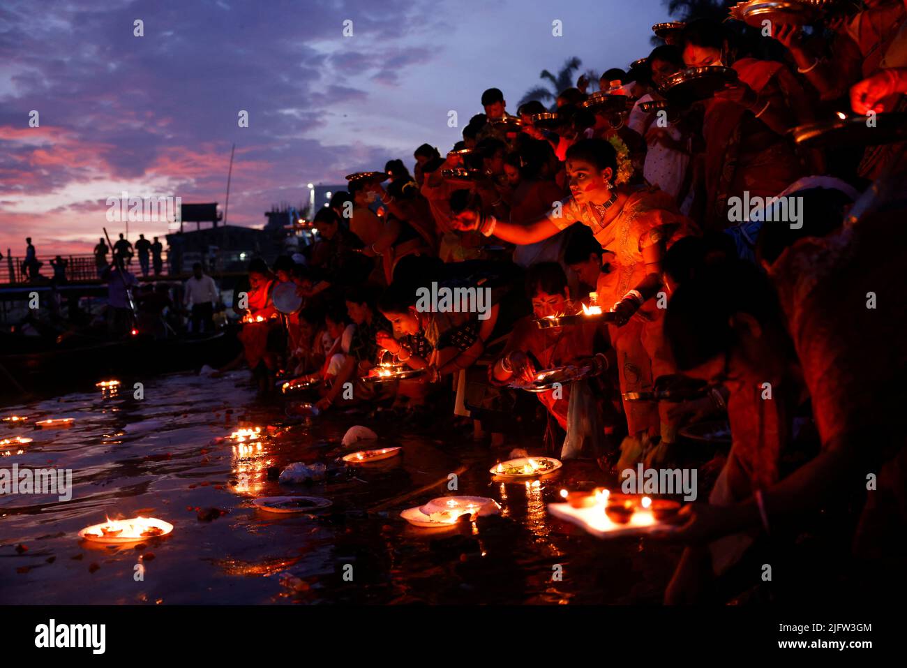 Hindu devotees release oil lamps to the Buriganga River as they observe Bipottarini Puja in Dhaka, Bangladesh, July 5, 2022. REUTERS/Mohammad Ponir Hossain     TPX IMAGES OF THE DAY Stock Photo