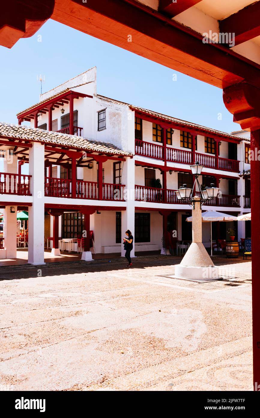 The Plaza de la Constitución, Plaza Mayor, in Puerto Lápice is a La Mancha-style square, with two levels of wooden arcades painted red. Puerto Lápice, Stock Photo
