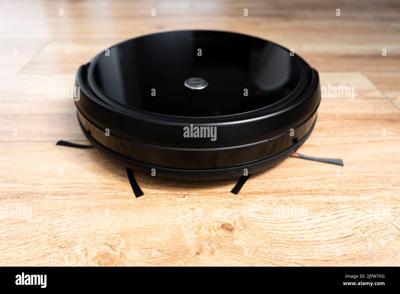 Robotic vacuum cleaner on laminate wood floor smart cleaning technology Stock Photo Alamy